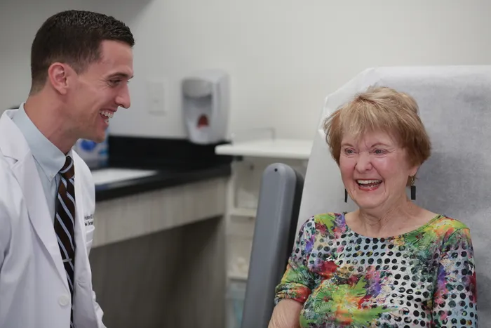 Doctor Hudson Laughing With Patient