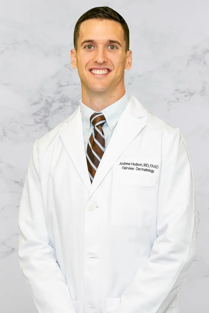 Dr. Hudson Standing in front of Practice and Smiling Warmly